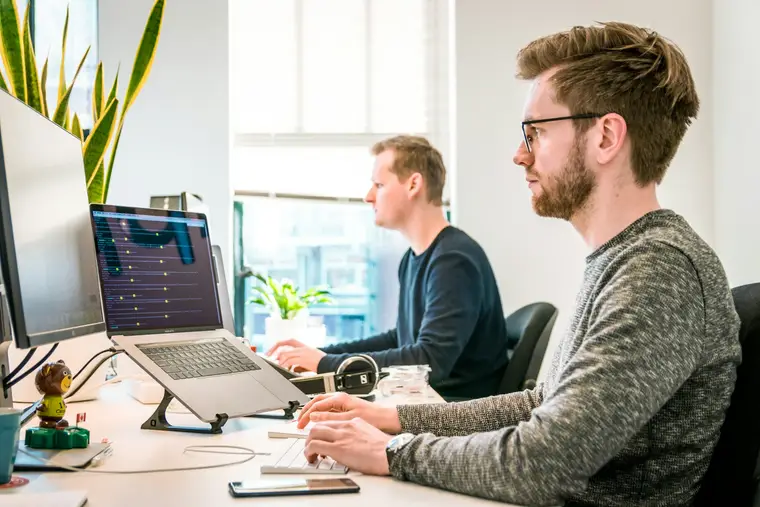 Team discussing an AI feature around a laptop
