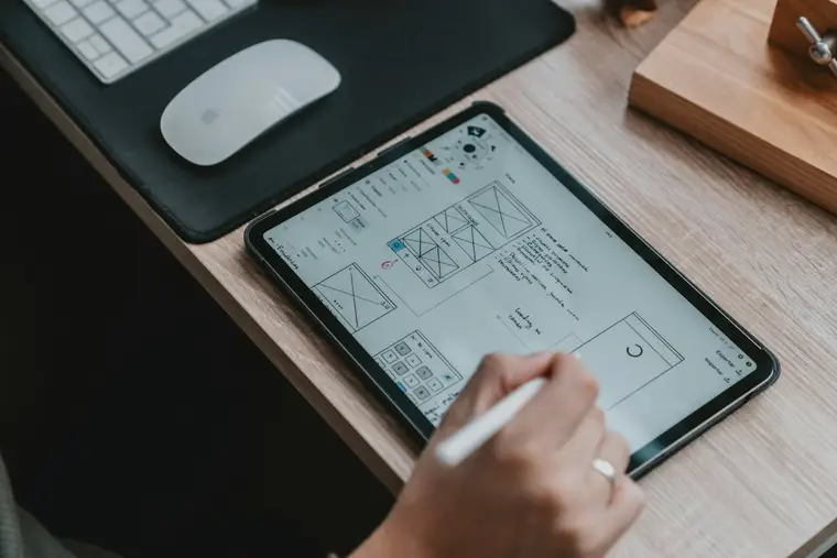 Designer sketching interface ideas on paper